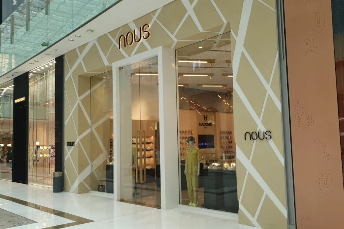Storefront of 'nous' with geometric design and 'nous' branding.